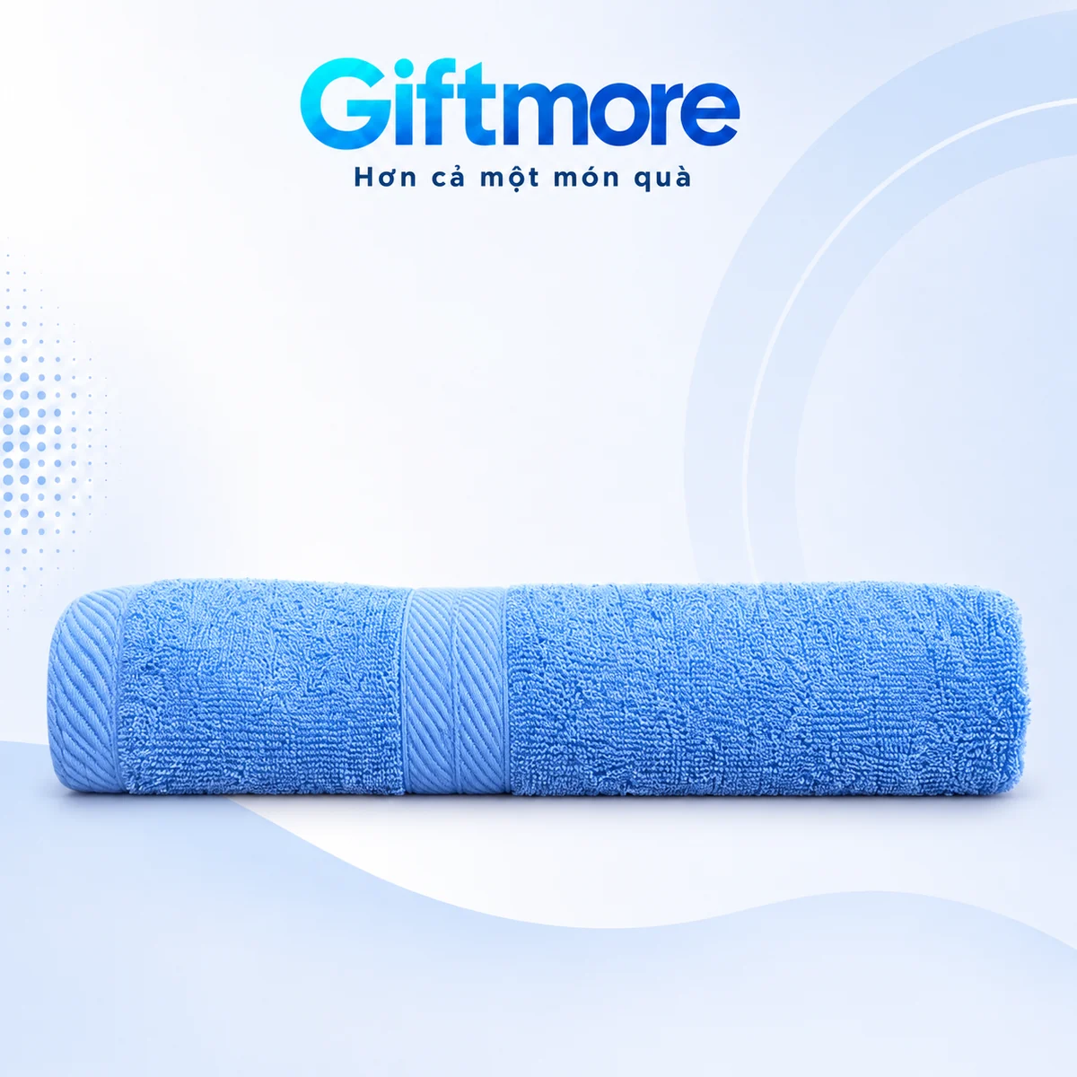 Khăn cotton xanh dương gấp ngang với dải dệt chéo trên nền GiftMore